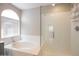 Bright bathroom featuring a tub, walk-in shower and natural light at 715 N Cholla St, Chandler, AZ 85224