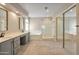Bright bathroom features dual sinks, large soaking tub, and glass-enclosed shower at 715 N Cholla St, Chandler, AZ 85224