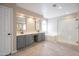 Bright bathroom features dual sinks, large soaking tub, and glass-enclosed shower at 715 N Cholla St, Chandler, AZ 85224