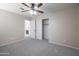 Neutral bedroom featuring plush carpet, ceiling fan, and double door closet for ample storage space at 715 N Cholla St, Chandler, AZ 85224