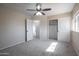 Bedroom with doorway, closet, plush carpet, neutral paint and a ceiling fan at 715 N Cholla St, Chandler, AZ 85224