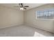 Bedroom featuring a ceiling fan, neutral paint, plush carpet and a window providing natural light at 715 N Cholla St, Chandler, AZ 85224