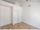 Bright bedroom with white walls, plank flooring, and a double-door closet at 715 N Cholla St, Chandler, AZ 85224