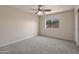 Bright bedroom featuring neutral walls, plush carpet, ceiling fan and a window providing natural light at 715 N Cholla St, Chandler, AZ 85224