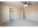 Neutral bedroom with plush carpet, closet, doorway and ceiling fan at 715 N Cholla St, Chandler, AZ 85224
