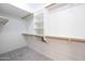 Walk-in closet features wooden bars and shelving for ample storage at 715 N Cholla St, Chandler, AZ 85224