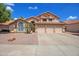 Charming two-story home with a three-car garage, desert landscaping, and tile roof at 715 N Cholla St, Chandler, AZ 85224