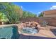 Backyard spa with rock waterfall, and stone tile at 715 N Cholla St, Chandler, AZ 85224