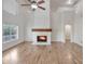 Bright living room features a fireplace, hardwood floors, large windows, and vaulted ceilings at 715 N Cholla St, Chandler, AZ 85224