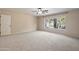 Spacious bedroom with carpet, ceiling fan, and natural light from the window at 715 N Cholla St, Chandler, AZ 85224