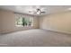 Spacious bedroom with carpet, ceiling fan, and natural light from the window at 715 N Cholla St, Chandler, AZ 85224