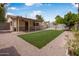 The artificial turf backyard has a covered patio and stone pavers at 7250 E Mckellips Rd, Scottsdale, AZ 85257