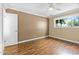 Laminate-floored bedroom featuring neutral walls, a ceiling fan, and a window for ample light at 7250 E Mckellips Rd, Scottsdale, AZ 85257