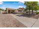 Cozy home with a front yard featuring mature landscaping and a covered carport, perfect for shade at 7250 E Mckellips Rd, Scottsdale, AZ 85257