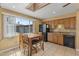 Open kitchen and dining area with natural light, tile flooring, and wooden cabinetry at 7250 E Mckellips Rd, Scottsdale, AZ 85257
