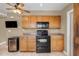 Kitchen featuring wood cabinets, black appliances, and a wine cooler for added convenience at 7250 E Mckellips Rd, Scottsdale, AZ 85257
