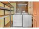 A laundry room has a washer and dryer, some metal shelving, and peg board at 7250 E Mckellips Rd, Scottsdale, AZ 85257