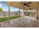 The home's covered patio overlooks an artificial turf lawn, has stone pavers and a ceiling fan at 7250 E Mckellips Rd, Scottsdale, AZ 85257