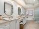 Elegant bathroom featuring double vanities, a soaking tub, and a glass-enclosed shower at 7955 E Chaparral Rd # 115, Scottsdale, AZ 85250