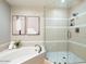 Bright bathroom featuring a soaking tub and walk-in glass shower at 7955 E Chaparral Rd # 115, Scottsdale, AZ 85250