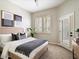 Serene bedroom with neutral colors, shuttered windows and comfortable decor at 7955 E Chaparral Rd # 115, Scottsdale, AZ 85250