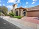 Charming home featuring a well-maintained front yard and a paved driveway leading to an attached garage at 7955 E Chaparral Rd # 115, Scottsdale, AZ 85250