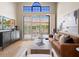 Open living room featuring high ceilings, large windows, and stylish furniture at 7955 E Chaparral Rd # 115, Scottsdale, AZ 85250