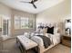 Calming main bedroom featuring neutral tones, plush bedding, and shuttered windows at 7955 E Chaparral Rd # 115, Scottsdale, AZ 85250