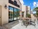 Charming patio with sliding glass doors and an outdoor dining set at 7955 E Chaparral Rd # 115, Scottsdale, AZ 85250