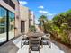 Outdoor patio area with a charming dining set and lush landscaping at 7955 E Chaparral Rd # 115, Scottsdale, AZ 85250