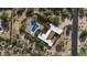 Overhead view of the property displaying the pool, patio, lush landscaping, and surrounding desert terrain at 8035 E Paraiso Dr, Scottsdale, AZ 85255
