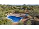 Aerial view of a backyard pool with a lounge area, patio, desert landscaping, and mountain views at 8035 E Paraiso Dr, Scottsdale, AZ 85255