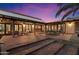 Backyard with large patio, multiple seating areas, and lovely sunset at 8035 E Paraiso Dr, Scottsdale, AZ 85255