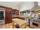 Gourmet kitchen featuring stainless steel appliances and a wooden island with butcher block top at 8035 E Paraiso Dr, Scottsdale, AZ 85255