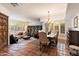 Spacious living room with brick accents, tile flooring, and a built-in bookshelf at 8035 E Paraiso Dr, Scottsdale, AZ 85255