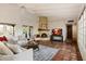 Bright living room with white ceiling beams, decorative fireplace, and terracotta tile flooring at 8035 E Paraiso Dr, Scottsdale, AZ 85255