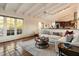 Open-concept living room with terracotta tile flooring and kitchen access at 8035 E Paraiso Dr, Scottsdale, AZ 85255