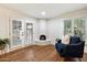 Bright main bedroom featuring a cozy fireplace, white brick walls and hardwood flooring at 8035 E Paraiso Dr, Scottsdale, AZ 85255