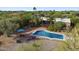 Aerial view of the backyard featuring a sparkling pool, brick patio, lounge chairs, and desert landscaping at 8035 E Paraiso Dr, Scottsdale, AZ 85255