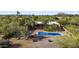 Aerial view showcasing the pool, patio, desert landscaping, and beautiful mountain views in the background at 8035 E Paraiso Dr, Scottsdale, AZ 85255