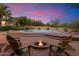 Relaxing poolside setting with chairs around fire pit, and lush landscaping at 8035 E Paraiso Dr, Scottsdale, AZ 85255