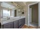Bathroom featuring a double vanity, large mirror, and separate tub and shower at 823 W Bradford Dr, Gilbert, AZ 85233