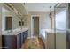 Bathroom featuring double sinks, a separate shower, and a soaking tub at 823 W Bradford Dr, Gilbert, AZ 85233