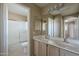 Bathroom featuring a double vanity, a large mirror, and a shower over the tub at 823 W Bradford Dr, Gilbert, AZ 85233