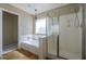 Bathroom with shower, bath tub, and a unique light fixture at 823 W Bradford Dr, Gilbert, AZ 85233
