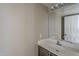 Bathroom showcasing a single vanity and a large mirror at 823 W Bradford Dr, Gilbert, AZ 85233
