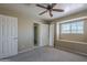 Bedroom featuring carpeted floors, a window with a bench, and ceiling fan at 823 W Bradford Dr, Gilbert, AZ 85233