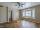 Bedroom features concrete flooring, a ceiling fan, and a bright window seat at 823 W Bradford Dr, Gilbert, AZ 85233