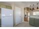 Spacious kitchen with green cabinets and open view to living room at 823 W Bradford Dr, Gilbert, AZ 85233