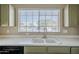 Kitchen sink with olive green cabinets beneath a bright window at 823 W Bradford Dr, Gilbert, AZ 85233